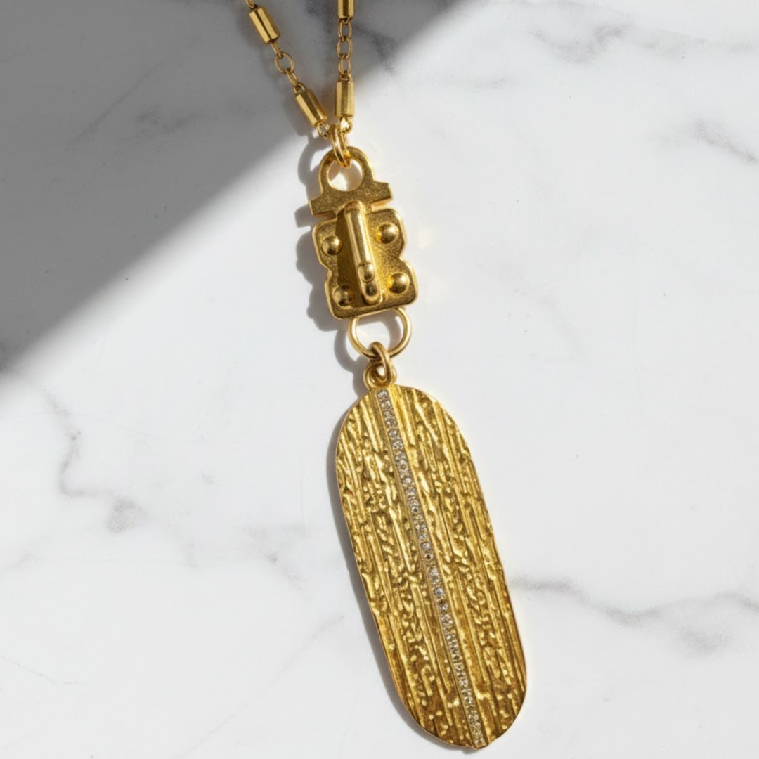 Handcrafted gold Hayden chain styled with a long vertical gold feather pendant.