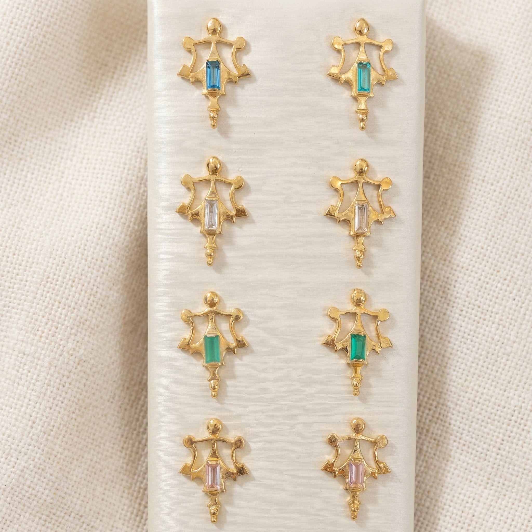 Roman artifact replica earrings in gold vermeil with various baguette stone accents.