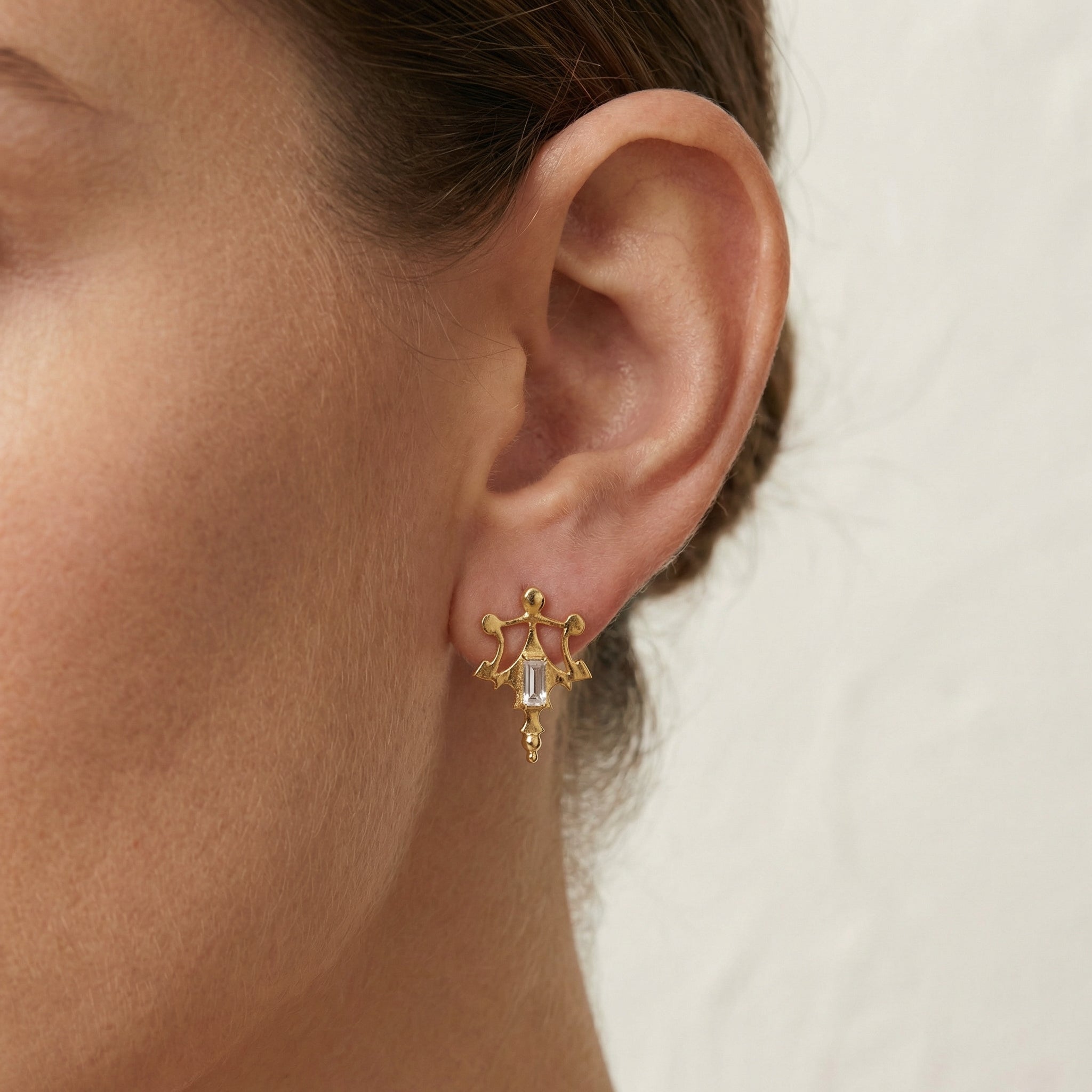 Crystal Roman-inspired post earrings showing the authentic ancient texture on the ear