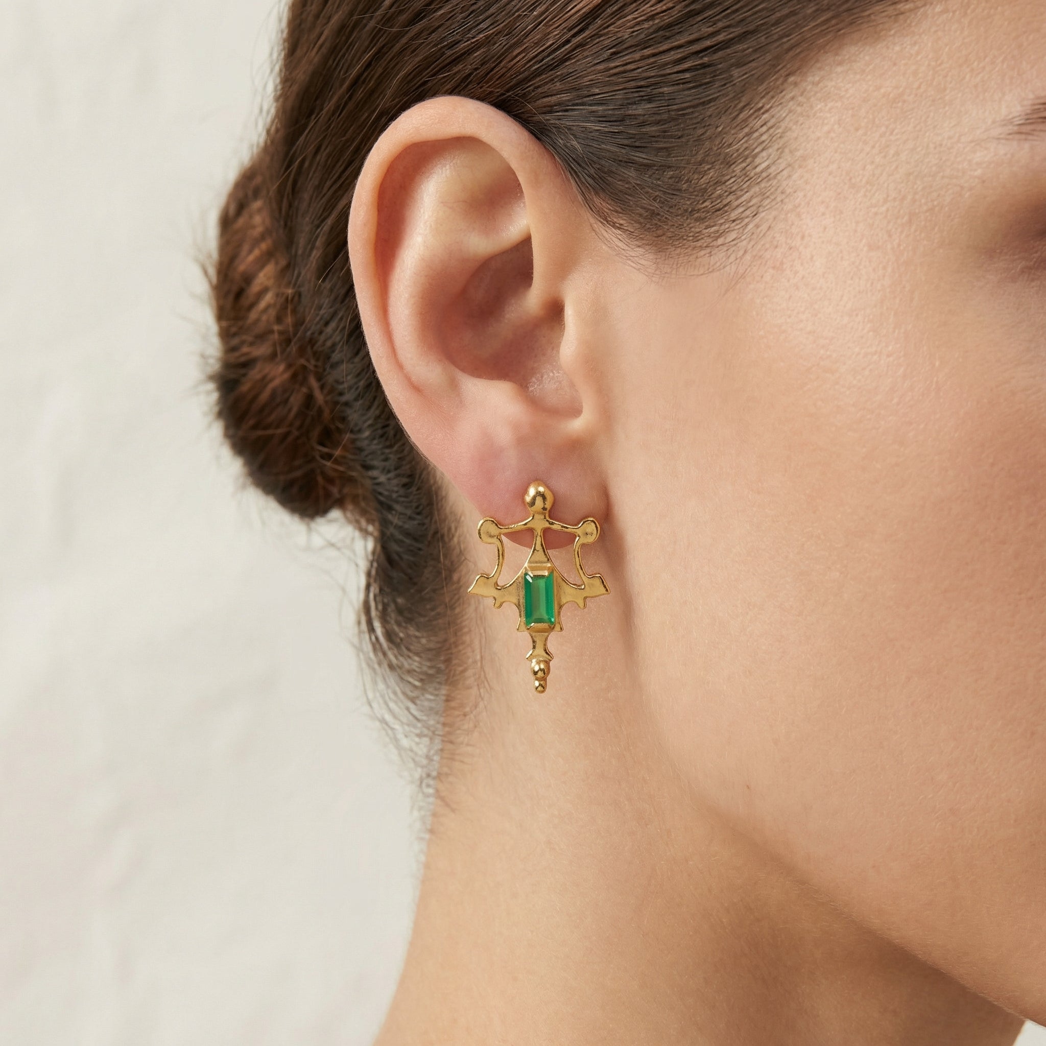 Gold Roman-inspired post earrings showing the authentic ancient texture on the ear